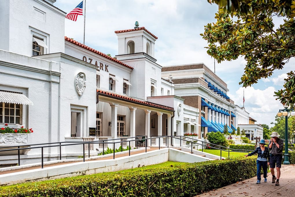 Couple walking past historic Hot Springs bath house